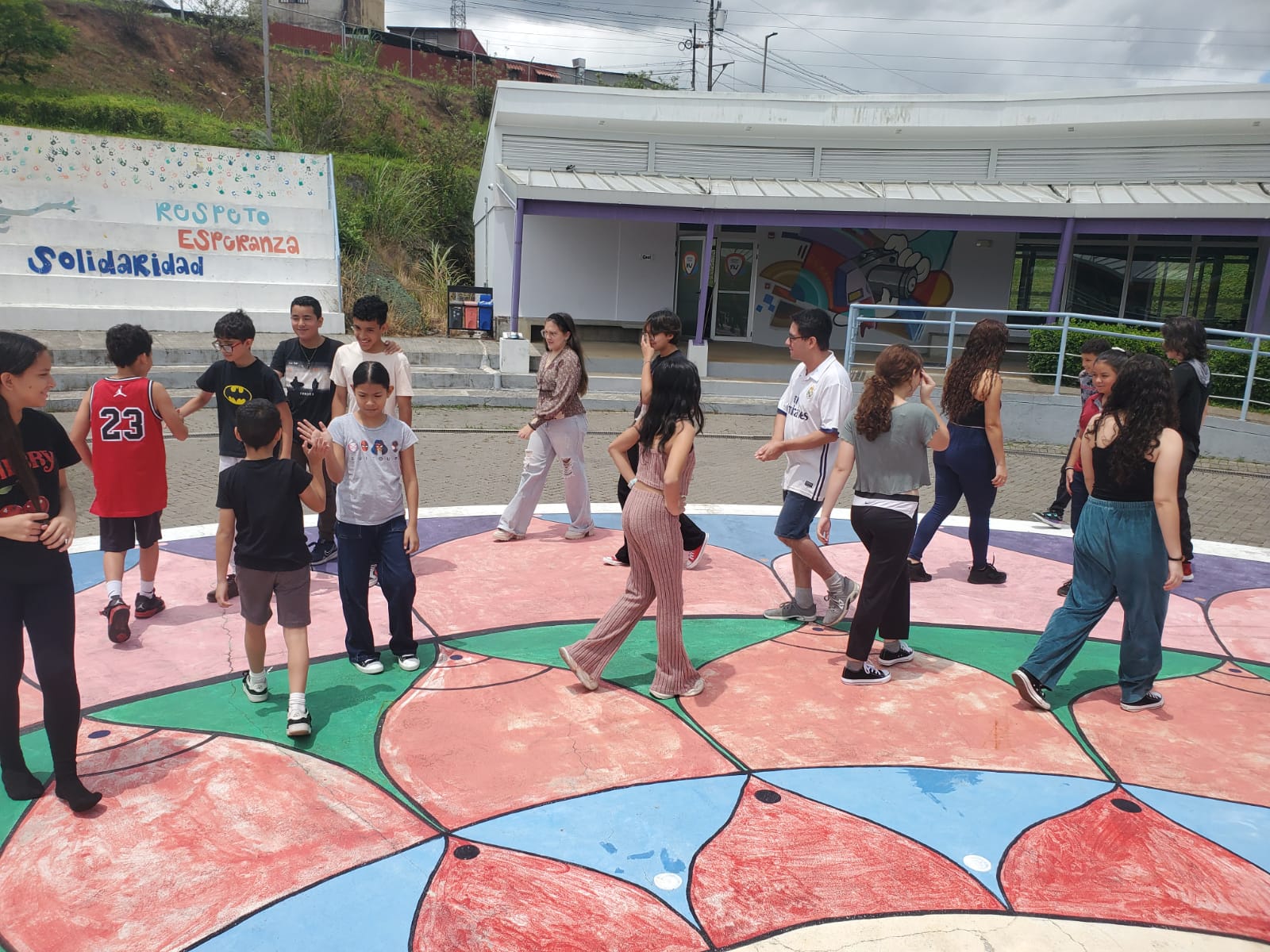 Niños y jóvenes caminando en una plazoleta