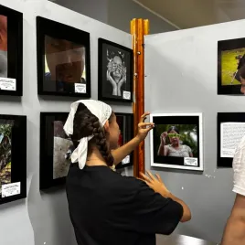Una mujer viendo una fotografía expuesta en la pared